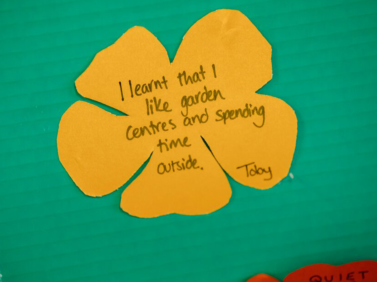 Paper flower with handwritten reflection from a pupil