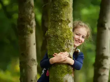 Student hugging a tree