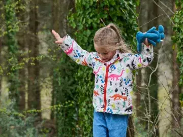 Child exploring in woodland area