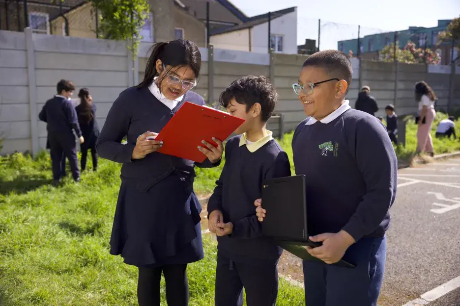 3 students with clipboards