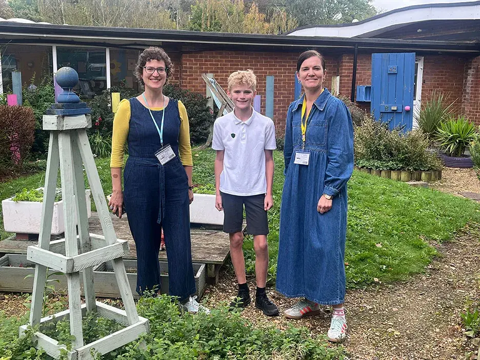 A student stands outside with Dr Jess Tipton and Helen Whitehouse