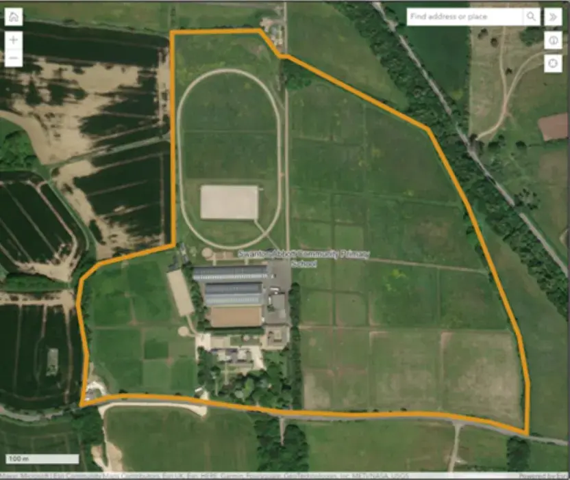 Aerial map of a school site with a yellow line indicating the site boundary